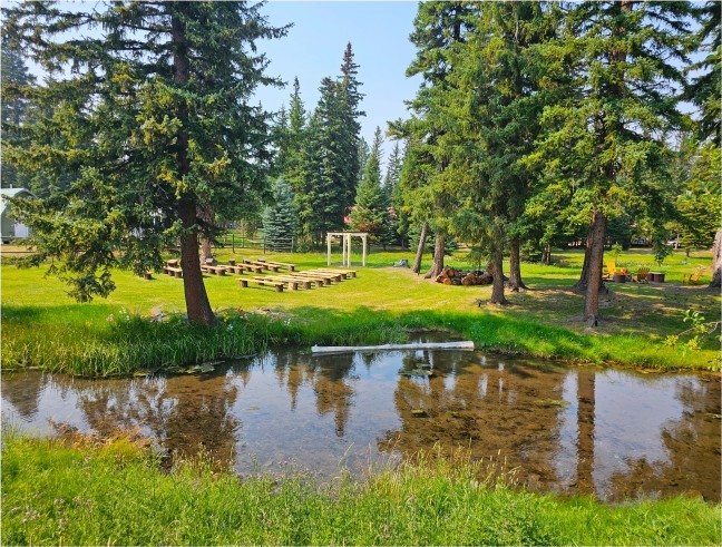 Creekside grounds with pergola gathering space for family reunions