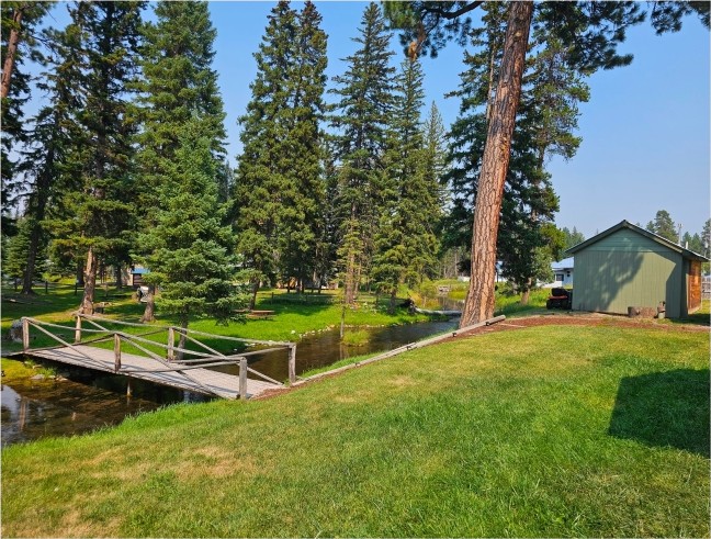Rustic log footbridge over Spring Creek on the grounds