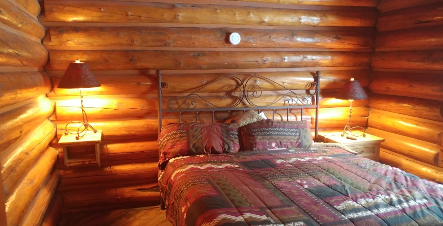 Rustic log cabin guest room with double bed