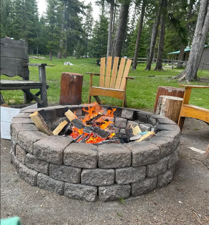 Outdoor stone fire pit at Lincoln Log Hotel